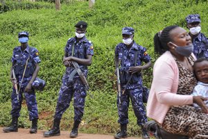 Security forces stand guard outside the campaign headquarters of Bobi Wine, a legislator whose real name is Kyagulanyi Ssentamu, in Kampala, Uganda