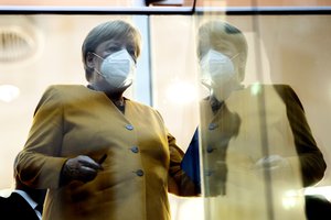 German Chancellor Angela Merkel leaves after a press conference in Berlin, Germany, Monday, Nov. 2, 2020.