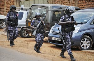 Ugandan riot police patrol on the streets of the Kamwokya neighborhood where pop star-turned-opposition lawmaker Bobi Wine, whose real name is Kyagulanyi Ssentamu, has his recording studio and many supporters, in Kampala, Uganda Thursday, Sept. 20, 2018.