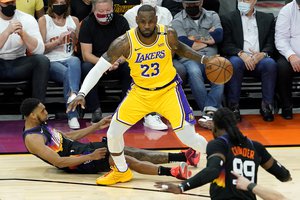 Los Angeles Lakers forward LeBron James (23) is fouled by Phoenix Suns forward Mikal Bridges during the first half of Game 5 of an NBA basketball first-round playoff series, Tuesday, June 1, 2021, in Phoenix