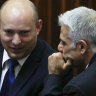 The new PMs: Yamina party leader Naftali Bennett, left, smiles as he speaks to Yesh Atid party leader Yair Lapid.