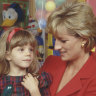 Princess Diana holds a child during a visit to London Lighthouse, a centre for people affected by HIV and AIDS, in 1996.