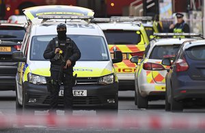 An armed Police officer blocks a street on the south side of London Bridge in London, Friday, Nov. 29, 2019