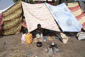 A young refugee from the Tigray region of Ethiopia waits to register at the UNCHR center at Hamdayet, Sudan on Saturday, Nov. 14, 2020.