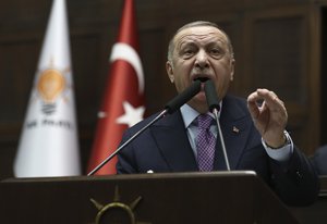 Recep Tayyip Erdogan speaks to his supporters at parliament, in Ankara, Turkey