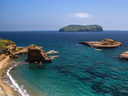 The turquoise rimmed coast of Ventotene, with the island of Santo Stefano in the distance