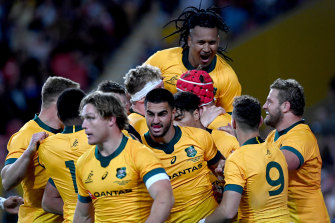 The Wallabies celebrate a try against the All Blacks last year. 