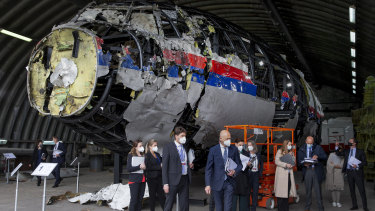 Presiding judge Hendrik Steenhuis, centre, and other trial judges and lawyers view the reconstructed wreckage of Malaysia Airlines Flight MH17.