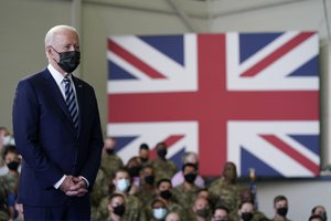 In this June 9, 2021, file photo, President Joe Biden listens as first lady Jill Biden speaks to American service members at RAF Mildenhall in Suffolk