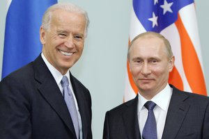 File photo: In this March 10, 2011 file photo, then Vice President Joe Biden, left, shakes hands with Russian Prime Minister Vladimir Putin in Moscow