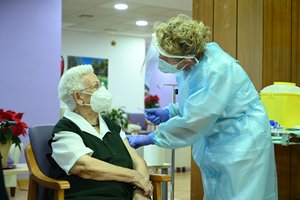 A resident of the Los Olmos nursing home for the elderly getting vaccinated against COVID-19, Guadalajara, Spain