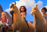 From left: Abigail Stone (Mckenna Grace) riding Boomerang, Lucky Prescott (Isabela Merced) riding Spirit and Pru Granger (Marsai Martin) riding Chica Linda in Spirit Untamed.