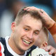 Sam Walker is mobbed by teammates after a try against the Titans.