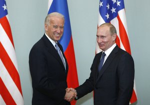 FILE - In this March 10, 2011, file photo, then-Vice President Joe Biden, left, shakes hands with Russian Prime Minister Vladimir Putin in Moscow, Russia.