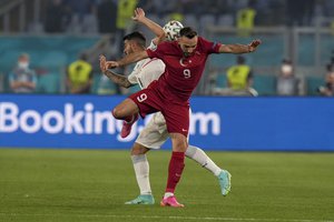 Turkey's Kenan Karaman is challenged by Italy's Leonardo Spinazzola during the Euro 2020, soccer championship group A match between Italy and Turkey, at the Rome Olympic stadium, Friday, June 11, 2021