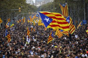 Protestors wave Estelada pro-independence flags during a demonstration in Barcelona, Spain, Friday, Oct. 18, 2019.