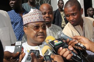 Presidential candidate Seini Oumarou speaks to the press after casting his vote at a polling station in Niamey, Niger