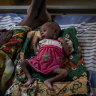 Abeba Gebru, 37, from the village of Getskimilesley, sits with her malnourished daughter, Tigsti Mahderekal, 20 days old, in the treatment tent of a medical clinic in the town of Abi Adi, in the Tigray region of northern Ethiopia.