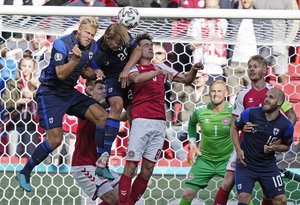 Finland's Joel Pohjanpalo, center left, and Denmark's Thomas Delaney, center, challenge for the ball during the Euro 2020 soccer championship group B match between Denmark and Finland at Parken stadium in Copenhagen, Saturday, June 12, 2021