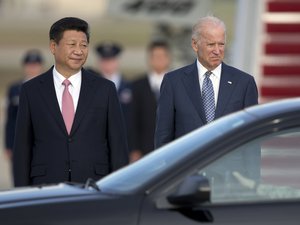 Chinese President Xi Jinping and Vice President Joe Biden stand together as President Xi Jinping prepares to board a motorcade during an arrival ceremony at Andrews Air Force Base, Md.