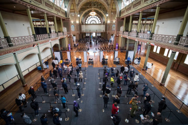 People wait to be vaccinated at Melbourne’s Royal Exhibition Building.