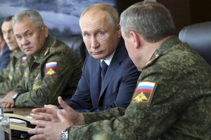 In this Sept. 25, 2020, file photo, Russian President Vladimir Putin, center, and Russian Defense Minister Sergei Shoigu, left, attend the main stage of the Kavkaz-2020 strategic command-and-staff exercises at the Kapustin Yar training ground, Russia.