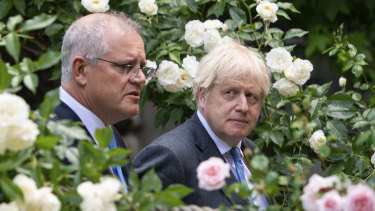 Prime ministers Scott Morrison and Boris Johnson walk to their joint press conference in the Downing Street garden.