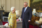 Britain’s Queen Elizabeth II, left receives Australian Prime Minister Scott Morrison during an audience in the Oak Room at Windsor Castle, in Windsor, England, Tuesday June 15, 2021. (Steve Parsons/Pool Photo via AP)