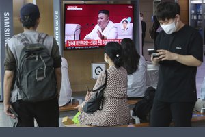 People watch a screen showing a file image of North Korean leader Kim Jong Un during a news program at the Seoul Railway Station in Seoul, South Korea, Friday, Sept. 25, 2020