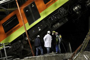 Personnel work in the rescue efforts after subway cars fell when a section of Line 12 of the subway collapsed in Mexico City, Tuesday, May 4, 2021