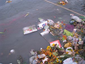 Plastic bags, garbage thrown in a river causing water pollution, Pune, India