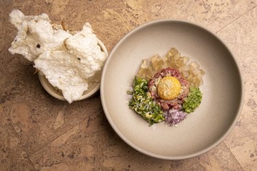 Beef tartare with egg yolk, pho jelly and anchovy tapioca crisps.