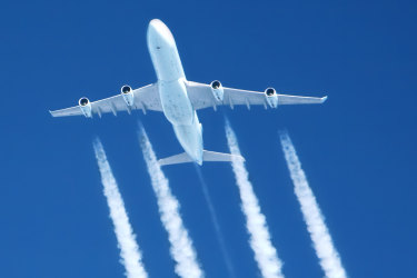 contrails streaming from a jumbo jet