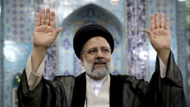 Ebrahim Raisi, Iran’s new President, waves to media after casting his ballot in Tehran on Friday. 