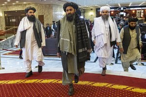 Taliban co-founder Mullah Abdul Ghani Baradar, center, arrives with other members of the Taliban delegation for an international peace conference in Moscow, Russia, Thursday, March 18, 2021.