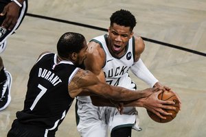 Brooklyn Nets' Kevin Durant (7) defends against Milwaukee Bucks' Giannis Antetokounmpo during the second half of Game 7 of a second-round NBA basketball playoff series Saturday, June 19, 2021, in New York