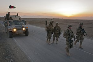 U.S. Army soldiers from 2nd Platoon, Company A, 1st Battalion, 2nd Infantry Regiment, Task Force Blackhawk, set up a traffic checkpoint with Afghan National Army soldiers in the frigid dawn of March 8, near Combat Outpost Yosef Khel