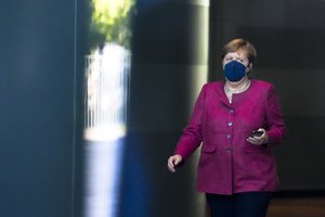 German Chancellor Angela Merkel waits for the arrival of Italian Prime Minister Mario Draghi for talks at the chancellery in Berlin, Germany, Monday, June 21, 2021.