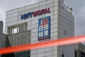 In this June 17, 2021, file photo, a cordon line is set up outside Apple Daily headquarters in Hong Kong.