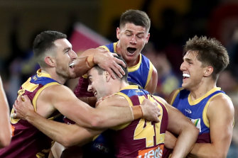 Lion James Madden is swarmed by his Lions teammates after a goal.