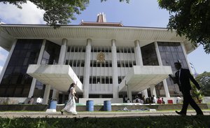 Sri Lankans walk in the Supreme Court premise in Colombo, Sri Lanka