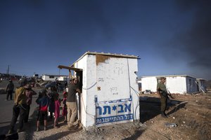 Israeli settlers are seen at the outpost of Eviatar near the northern West Bank town of Nablus, Monday, June 21, 2021