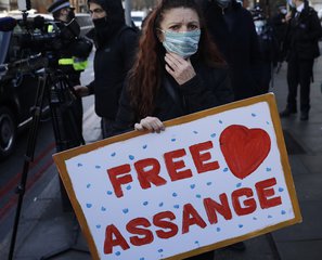 File - A Julian Assange supporter reacts outside the Westminster Magistrates Court after Julian Assange was denied bail at a hearing in the court in London, Wednesday, Jan. 6, 2021.