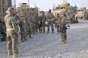 U.S. Army Sgt. 1st Class Jason Alaniz (right) with Alpha Troop, Regimental Support Squadron, Combined Task Force Dragoon, speaks with his troops before convoy operations July 30, 2013, at Kandahar Airfield, Afghanistan