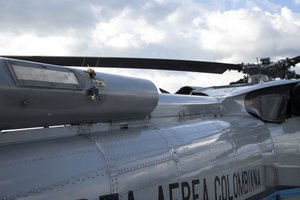 In this photo released by Colombia's Presidency, bullet holes are seen on the fuselage of a Colombian Air Force helicopter that were fired while Colombia's President Ivan Duque and members of his cabinet were traveling on the helicopter, at the airport in Cucuta, Colombia, Friday, June 25, 2021