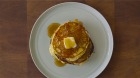 Buttermilk pancakes with butter and maple syrup.