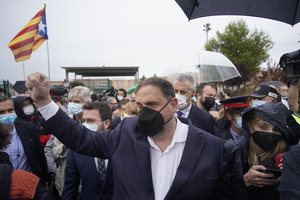 Former deputy president of the Catalan regional government Oriol Junqueras raises his fist in front of an "estelada" or Catalan pro-independence flag after being released from the Lledoners prison in Sant Joan de Vilatorrada near Barcelona, Spain, Wednesday, June 23, 2021