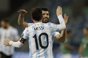 Argentina's Lionel Messi, 10, celebrates scoring his side's third goal with teammate Sergio Aguero during a Copa America soccer match against Bolivia at Arena Pantanal stadium in Cuiaba, Brazil, Monday, June 28, 2021