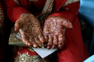 A Kashmiri Shiite Muslim bride prays during a mass marriage event in Srinagar, Indian controlled Kashmir, Sunday, July. 15, 2018.