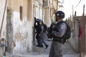 Israeli Police move into position during clashes with protesters after a shop was demolished by the municipality in the Silwan neighborhood of east Jerusalem, Tuesday, June 29, 2021